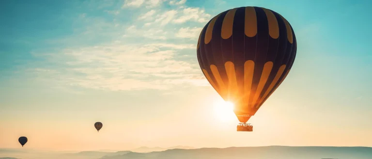 Hot air balloon flying at sunrise over the countryside – Hot Air Balloon Marrakech