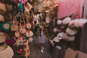 Colorful stalls and shoppers in the souks of the Marrakech medina