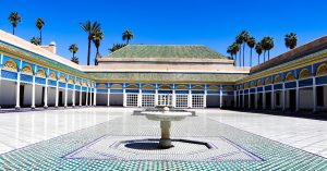 Courtyard of the Bahia Palace in Marrakech with zellij tiles and carved wood