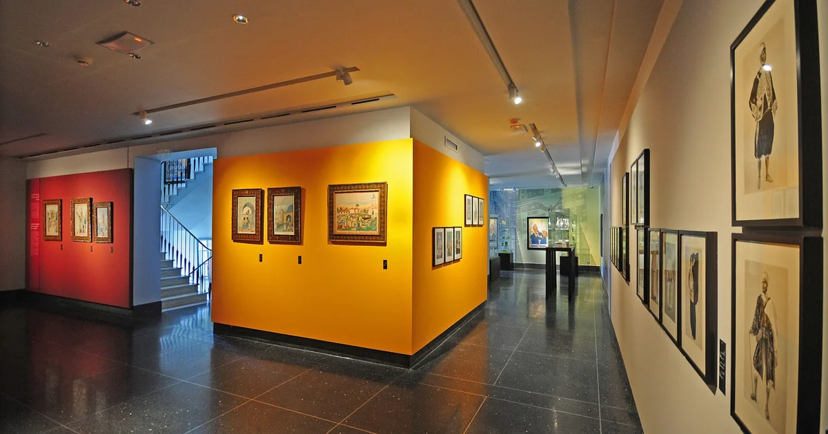 A colorful collection of vintage Moroccan travel posters on display at the Abderrahman Slaoui Museum