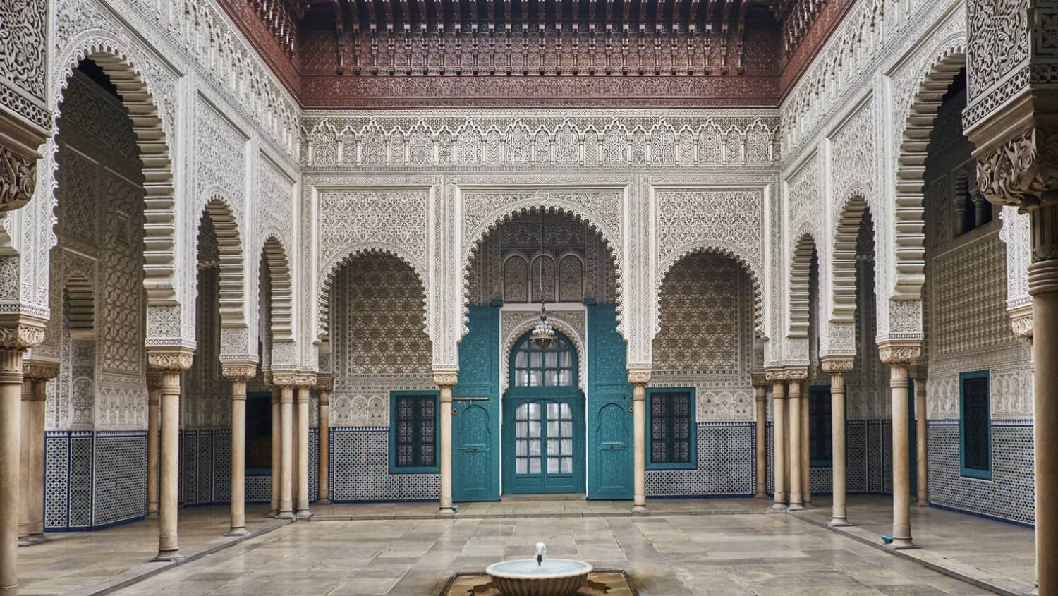 The stunning interior courtyard of the Mahkama du Pacha, featuring ornate tilework and carved wooden details