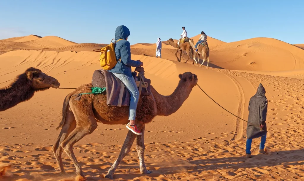Camel riders in the dunes on the 7 day desert tour from Marrakech