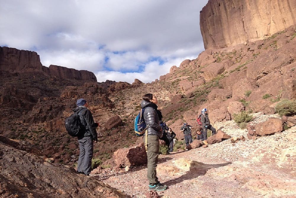 Trekking in Jebel Saghro through dramatic volcanic landscapes and Sahara desert dunes in southern Morocco